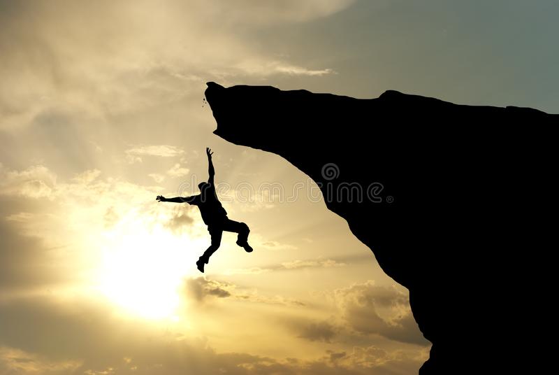 A photograph of a man falling off a mountain cliff.