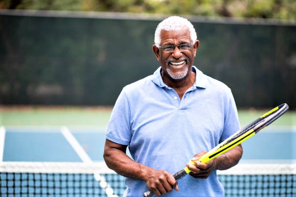 Man holding tennis racquet on court.
