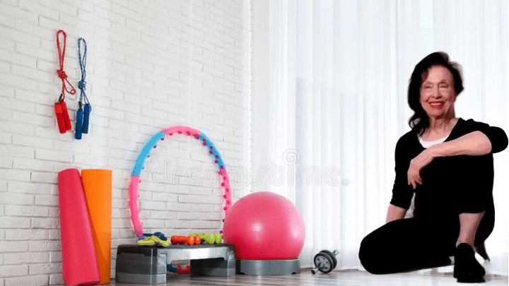 Irene Pastore, Personal Trainer, sitting in a fitness studio surrounded by equipment for core training, ready to guide active adults 55+.