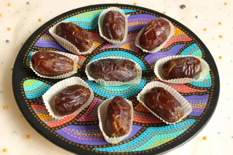 Medjool dates arranged on a colorful serving plate.